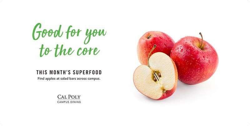 Three red apples, one cut in half, with text "Good for you to the core. This month's superfood: Find apples at salad bars across campus.