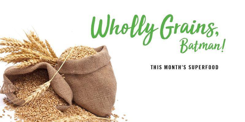 Burlap sacks filled with grains and wheat stalks next to text "Wholly Grains, Batman! This month’s superfood.