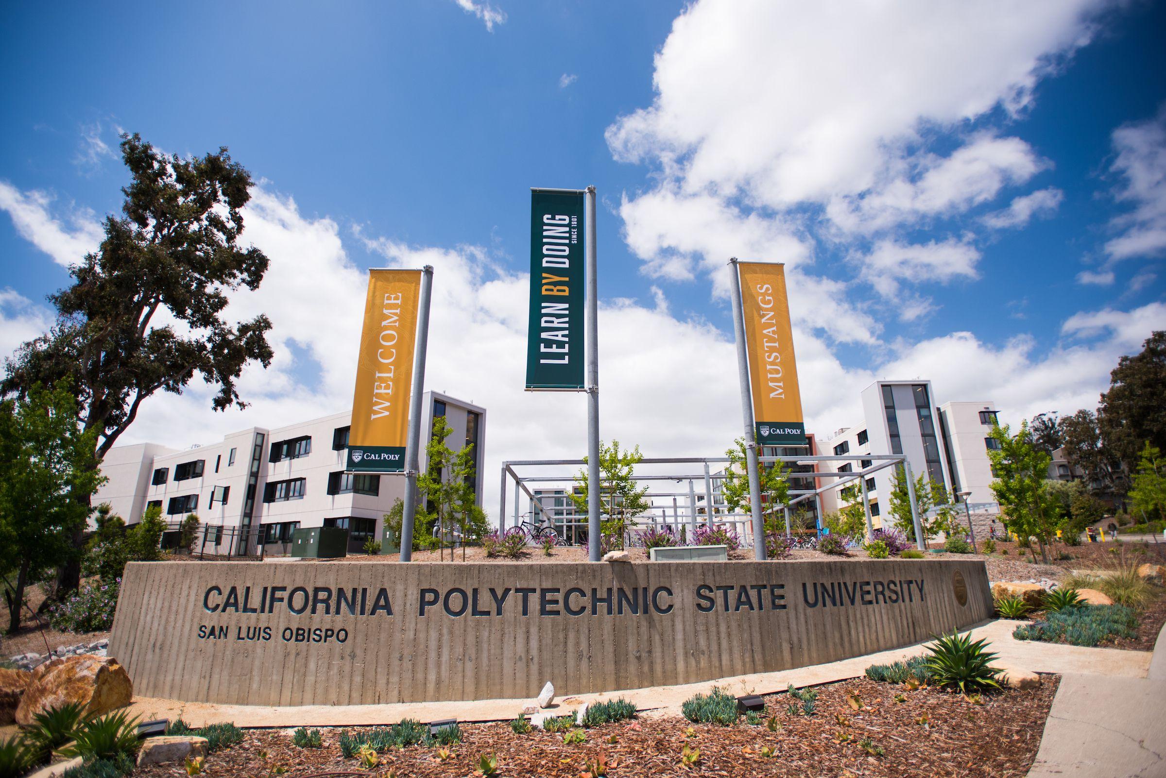California Polytechnic State University San Luis Obispo entrance with banners reading Welcome, Learn By Doing, Mustangs.