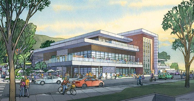 Modern two-story building with large windows, balconies, people walking and cycling, and surrounding trees.