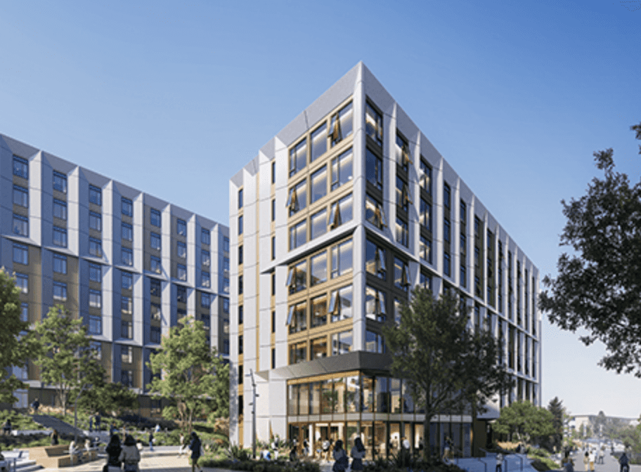 Modern multi-story building with large glass windows surrounded by trees and people walking on sunny day.
