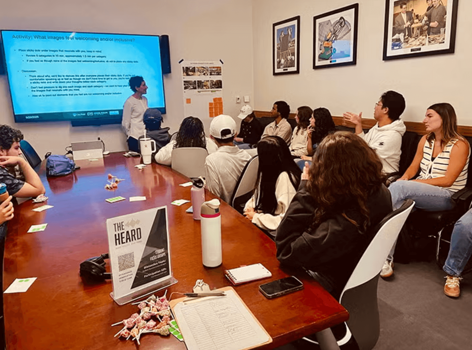 Group of people seated in a conference room attending a presentation on inclusivity with slides displaying activity instructions.